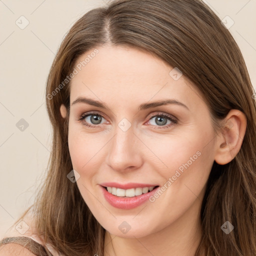 Joyful white young-adult female with long  brown hair and grey eyes