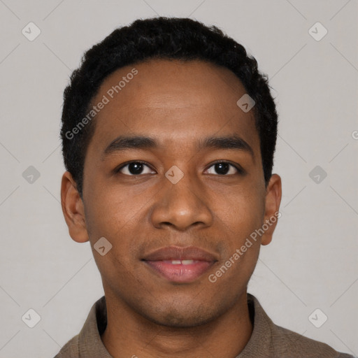 Joyful black young-adult male with short  black hair and brown eyes