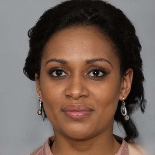 Joyful latino young-adult female with short  black hair and brown eyes