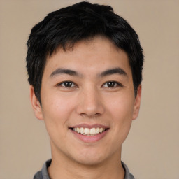 Joyful asian young-adult male with short  brown hair and brown eyes