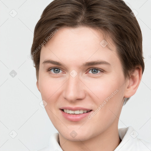 Joyful white young-adult female with short  brown hair and grey eyes