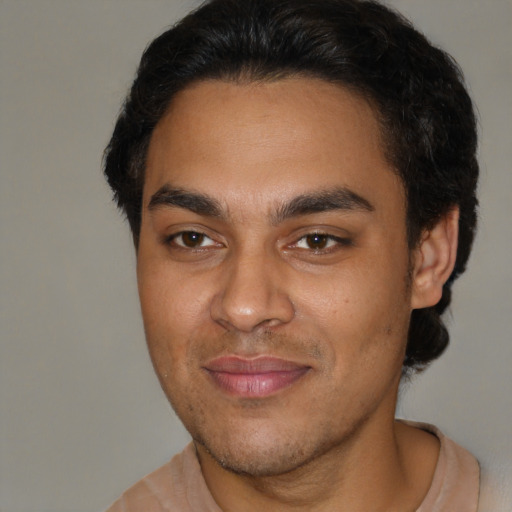 Joyful latino young-adult male with short  brown hair and brown eyes