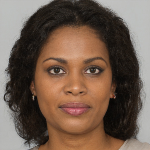 Joyful black young-adult female with medium  brown hair and brown eyes