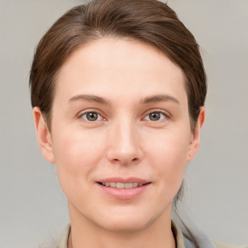 Joyful white young-adult female with short  brown hair and grey eyes