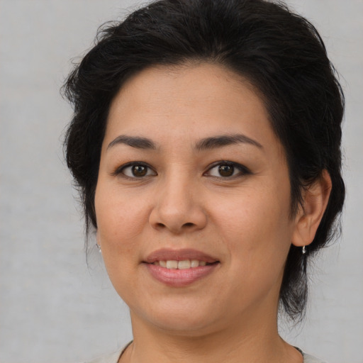 Joyful asian young-adult female with medium  brown hair and brown eyes