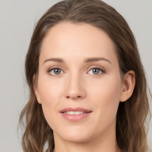 Joyful white young-adult female with long  brown hair and grey eyes