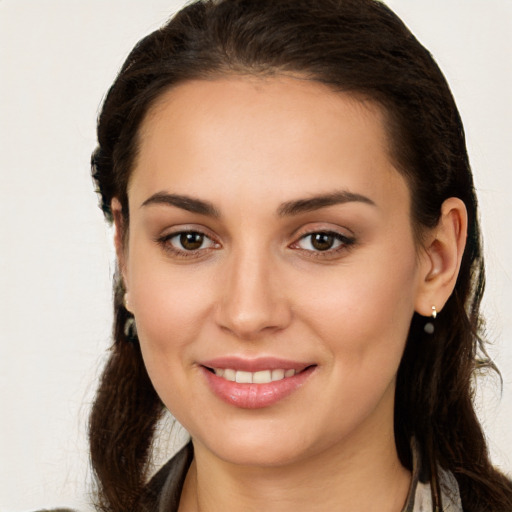 Joyful white young-adult female with long  brown hair and brown eyes