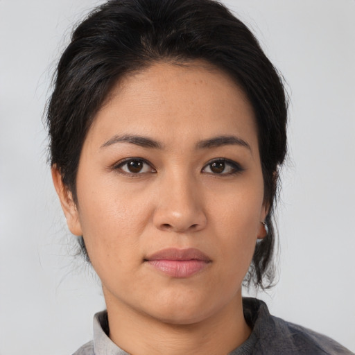 Joyful asian young-adult female with medium  black hair and brown eyes