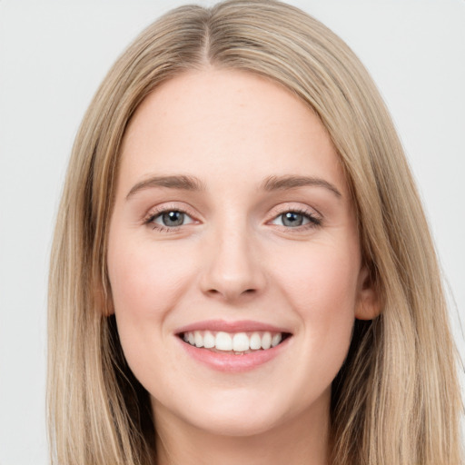 Joyful white young-adult female with long  brown hair and green eyes