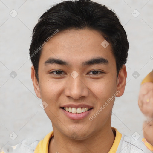 Joyful asian young-adult male with short  brown hair and brown eyes