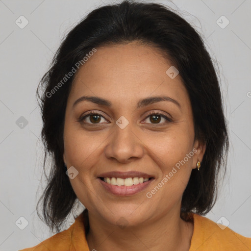 Joyful latino adult female with medium  brown hair and brown eyes