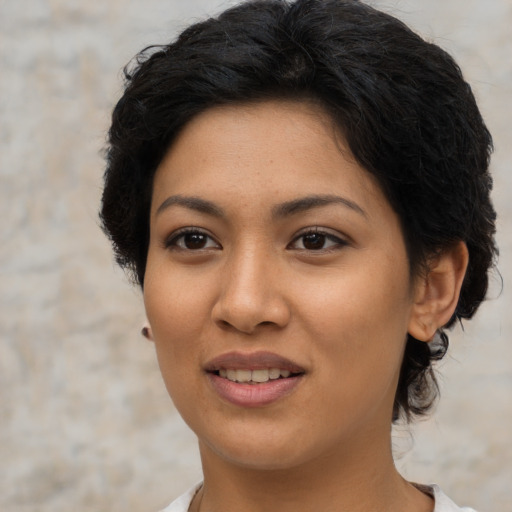 Joyful asian young-adult female with short  brown hair and brown eyes