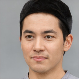 Joyful asian young-adult male with short  black hair and brown eyes