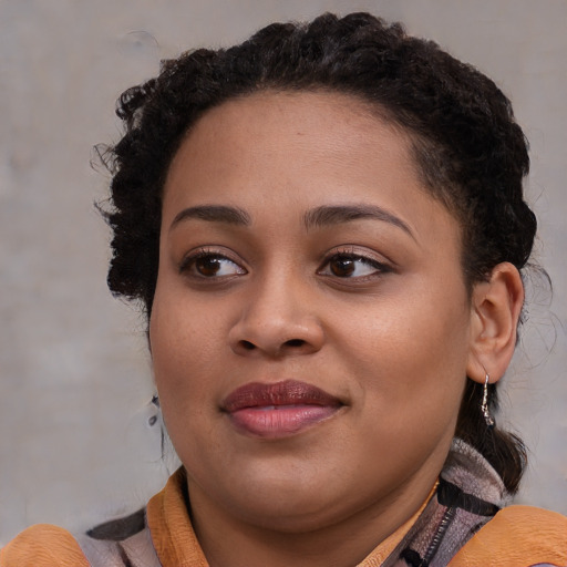 Joyful black young-adult female with medium  brown hair and brown eyes