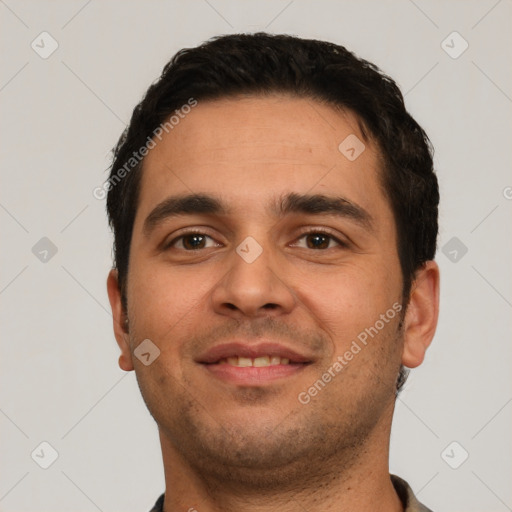 Joyful white young-adult male with short  black hair and brown eyes