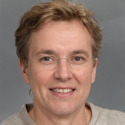 Joyful white adult male with short  brown hair and grey eyes