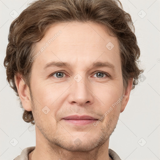 Joyful white adult male with short  brown hair and grey eyes