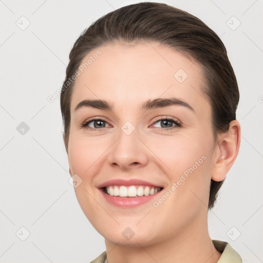 Joyful white young-adult female with short  brown hair and brown eyes