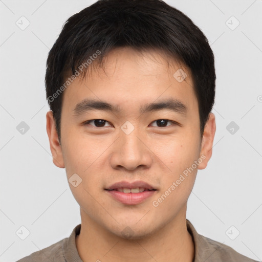 Joyful asian young-adult male with short  brown hair and brown eyes