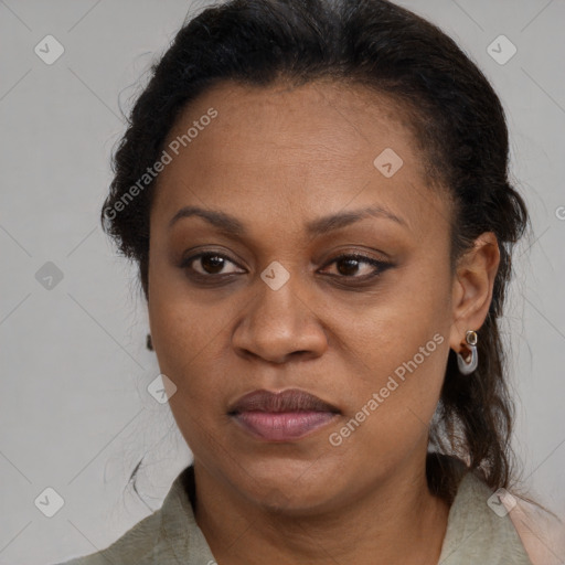 Joyful black adult female with medium  brown hair and brown eyes