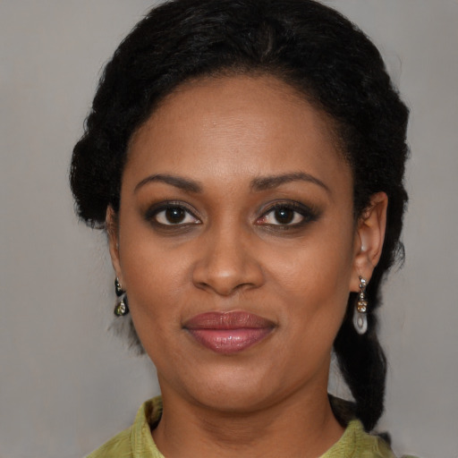 Joyful black young-adult female with medium  black hair and brown eyes