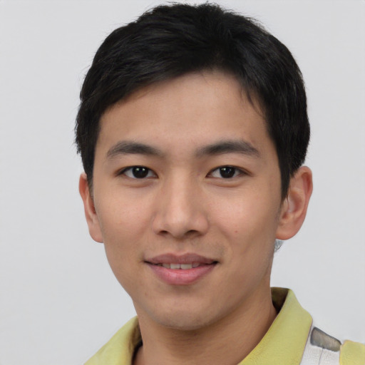 Joyful asian young-adult male with short  brown hair and brown eyes