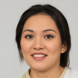 Joyful latino young-adult female with medium  brown hair and brown eyes