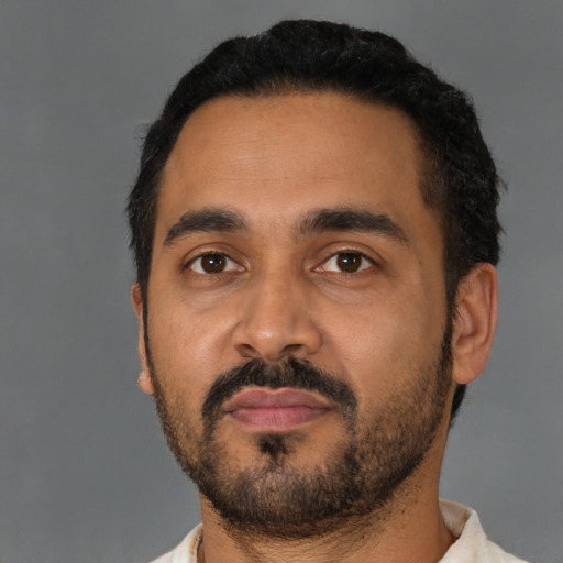 Neutral latino young-adult male with short  black hair and brown eyes