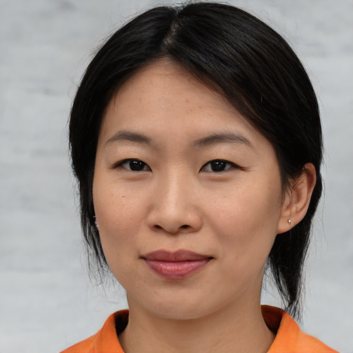 Joyful asian young-adult female with medium  black hair and brown eyes