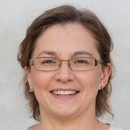 Joyful white adult female with medium  brown hair and grey eyes