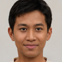 Joyful asian young-adult male with short  brown hair and brown eyes