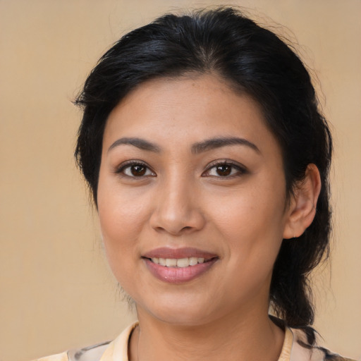 Joyful latino young-adult female with medium  brown hair and brown eyes