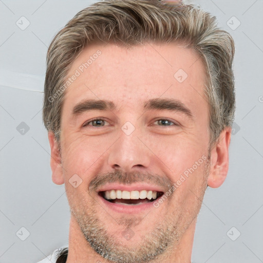 Joyful white young-adult male with short  brown hair and grey eyes