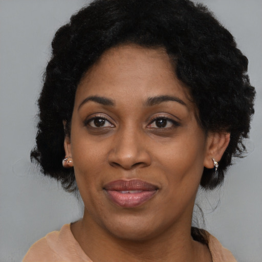 Joyful black young-adult female with medium  black hair and brown eyes