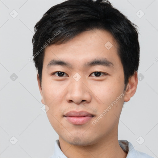 Joyful asian young-adult male with short  black hair and brown eyes