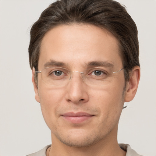 Joyful white adult male with short  brown hair and brown eyes