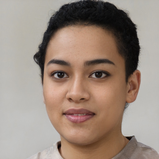 Joyful latino young-adult female with short  black hair and brown eyes
