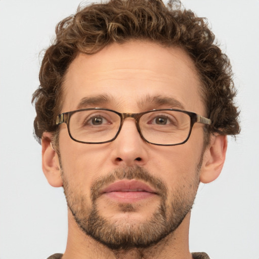 Joyful white adult male with short  brown hair and green eyes