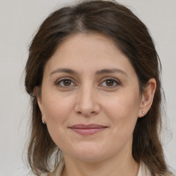 Joyful white adult female with medium  brown hair and brown eyes