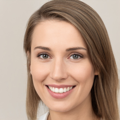 Joyful white young-adult female with long  brown hair and grey eyes