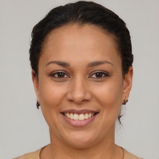 Joyful latino adult female with short  brown hair and brown eyes