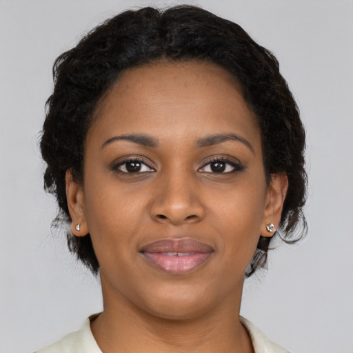 Joyful black young-adult female with short  brown hair and brown eyes
