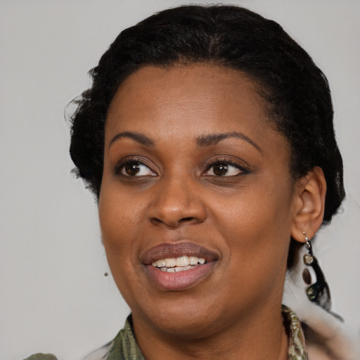 Joyful black adult female with medium  black hair and brown eyes