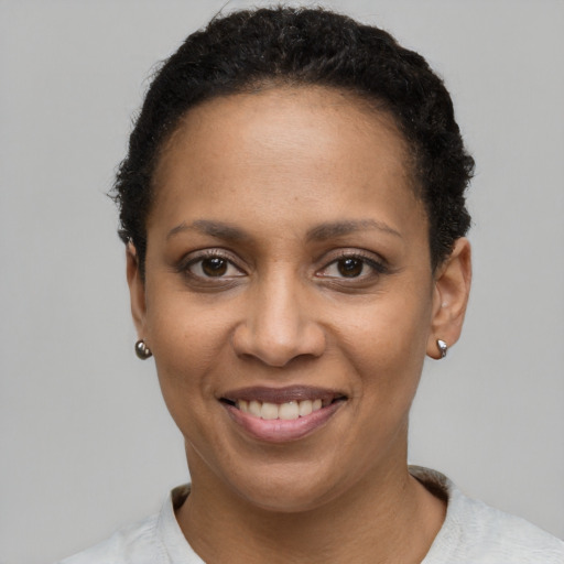 Joyful latino young-adult female with short  black hair and brown eyes