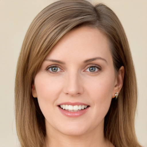 Joyful white young-adult female with long  brown hair and green eyes