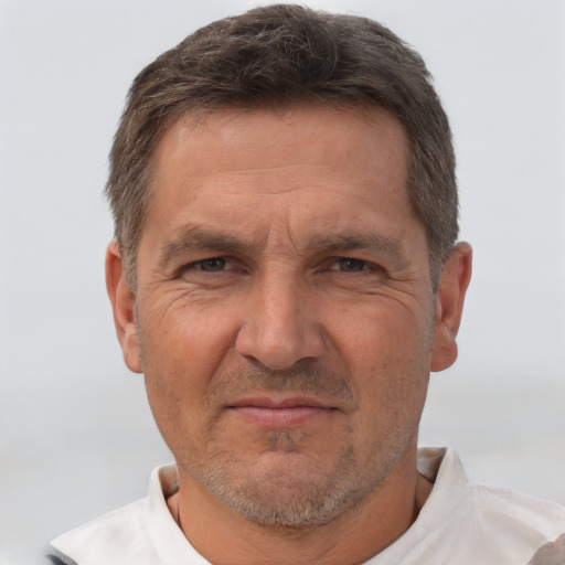 Joyful white middle-aged male with short  brown hair and brown eyes