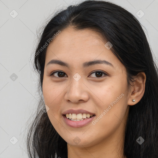 Joyful asian young-adult female with long  black hair and brown eyes