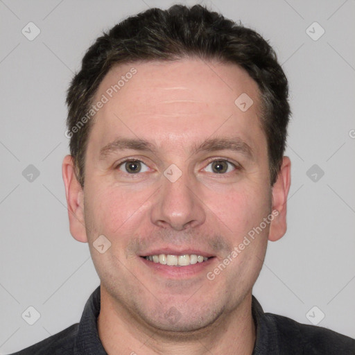 Joyful white adult male with short  brown hair and grey eyes