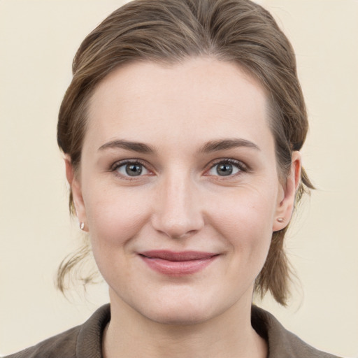 Joyful white young-adult female with medium  brown hair and grey eyes