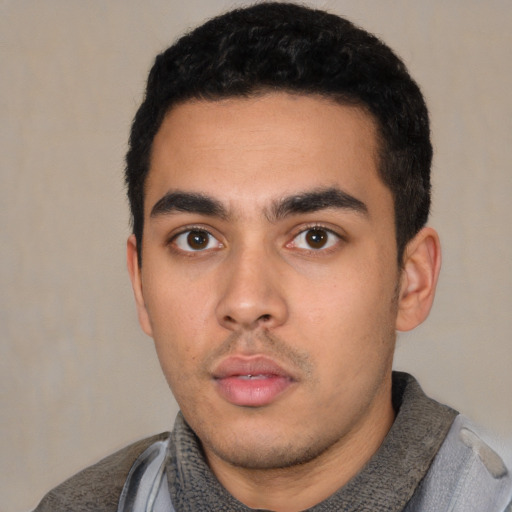 Neutral latino young-adult male with short  black hair and brown eyes